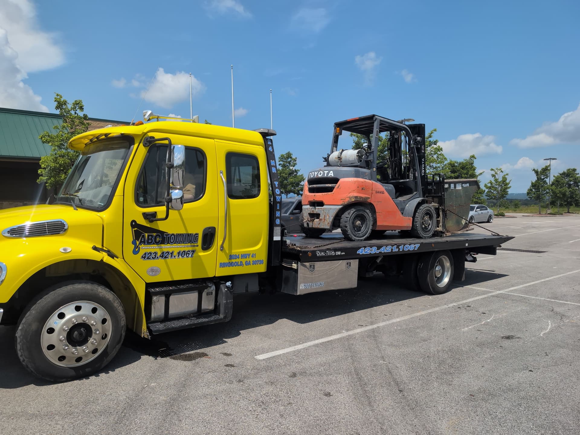 Forklift and Dumpster Hauled to Keep a Job Site Moving image